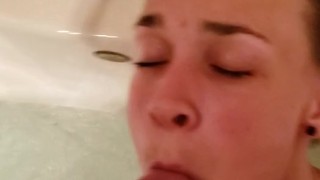 Playing in the tub while she sucks my cock