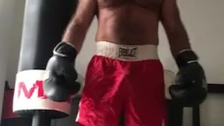 working the bag in red boxing trunks