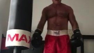 working the bag in red boxing trunks