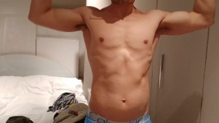 stripping and flexing through my hoodie, tanktop, briefs flexing my muscles