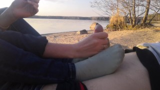 public footjob and socksjob on the beach