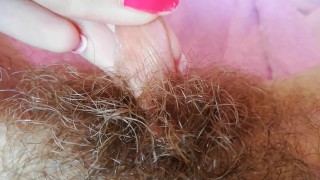 Playing with my big clit hood pulling and stretching hairy bush pussy close