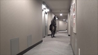 jerking off in hotel hall in wetsuit and trench coat