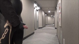 jerking off in hotel hall in wetsuit and trench coat