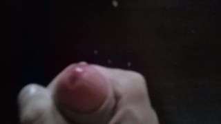 Russian skinny guy jerks off a big cock in front of the mirror and cums on the table