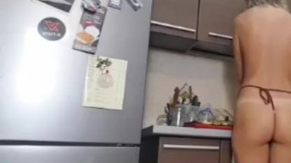 Cute teen painting Easter eggs and dancing in the kitchen