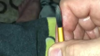 Trying to stuff little penis hole with paint brush