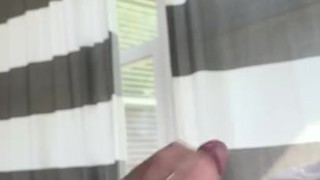 Skinny guy masturbating in a room full of windows