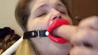 Trying to talk while giving a blowjob to Dildo, wearing open mouth gag