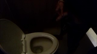 Guy pisses in a public toilet