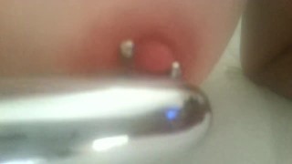 Play with my pierced nipples with silver vibrator