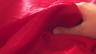 Man In Latex Catsuit Rubbing Cock With Satin Sheets