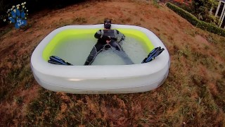 Rufus pawing off in wetsuit, fins and pool