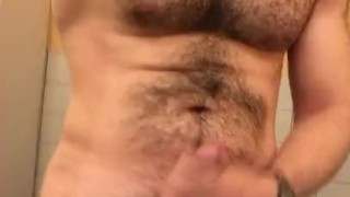 Muscled hung hairy stud jerking in public restroom