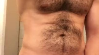 Muscled hung hairy stud jerking in public restroom