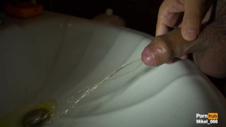 Dick pissing in the sink, slow motion 100fps