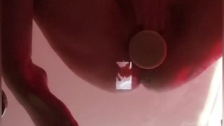 Big tits brunette masturbating on glass table