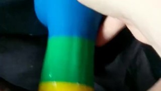 Cumming on a rainbow dildo in bed