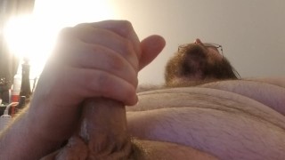 Chubby guy cums on himself.