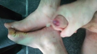 Gym fit male athlete flings spunk all over his tired feet.