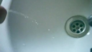 Uncut cock gets semi while pissing!