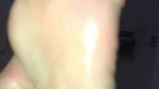 Thick ebony toes dripping oil in slow motion