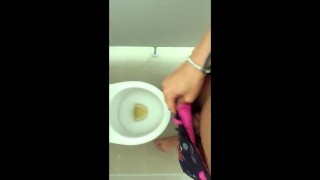 Tattooed twink is pissing in waterpark piss filled toilet