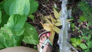 Girl In Swim Suit Pees On Fallen Tree By River
