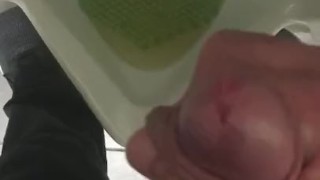 Pissing in a urinal in public at work