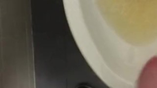 POV pissing into a toilet in a public bathroom and jerking off and cumming