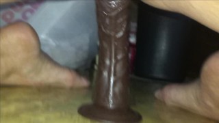 Hot girl rides black dildo until she loudly cums.