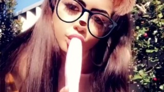 Slutty teen sucks a dildo outside