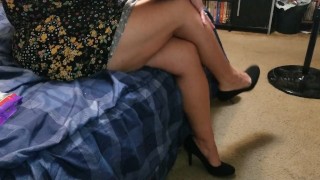 Sexy wife dangling high heels crossing legs adjusting skirt