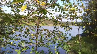 A village guy jerks off a big cock on the river bank, and fishermen swim by on a boat