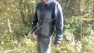A village guy jerks off a big cock on the river bank, and fishermen swim by on a boat