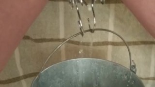 BDSM Pussy Labia Stretching Weight Torture Pissing in a Bucket Clamped Lips