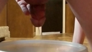 Pissing in a bowl on all fours.