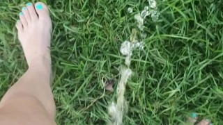 Girl Pees While Walking In Grass