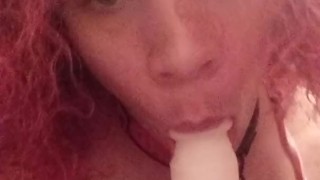 Cute crossdresser in pink sucks dildo