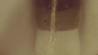 Close-up hairy pussy pissing on public toilet after holding 