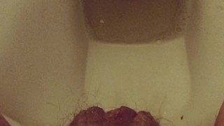 Close-up hairy pussy pissing on public toilet after holding 