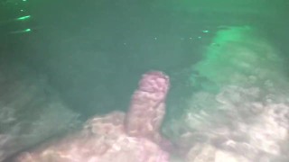Underwater jerk off session in backyard in steamy hot tub glowing at night.