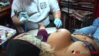 Shyla Stylez gets tattooed while playing with her tits