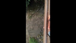 Twink piss from the bridge into the river