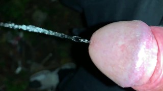 Slowmotion and close up - Unwashed uncut cock piss on the ground outdoor - long piss stream