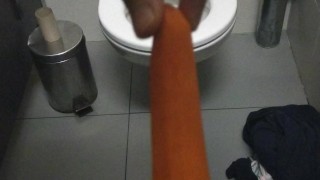 Public restroom masturbation with a carrot while people are around