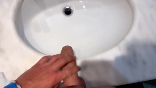 Quick hotel bathroom cumshot into sink in swim trunks while friend is gone