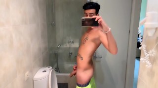 Quick hotel bathroom cumshot into sink in swim trunks while friend is gone