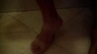 Soapy shower feet and rubbing one down - peephole view