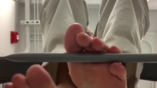 My bare soles from under a barstool 